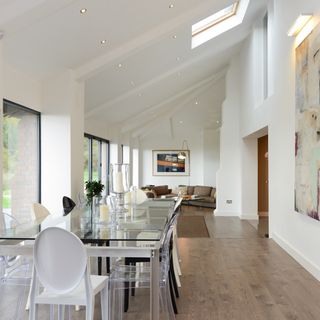 dining area with glass dining table and wooden flooring