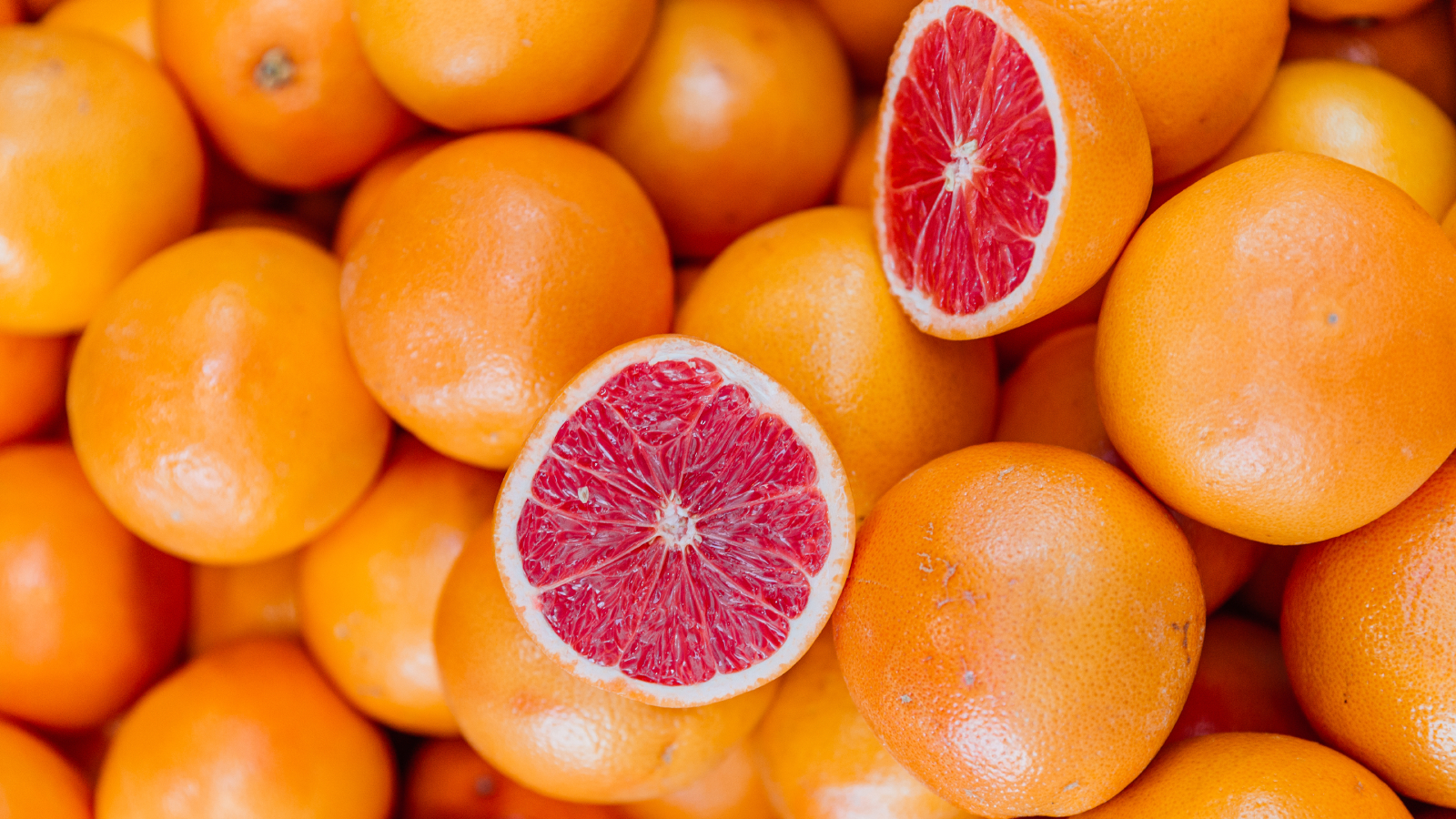 Grapefruit cut in half on pile of grapefruits to create grapefruit slug trap