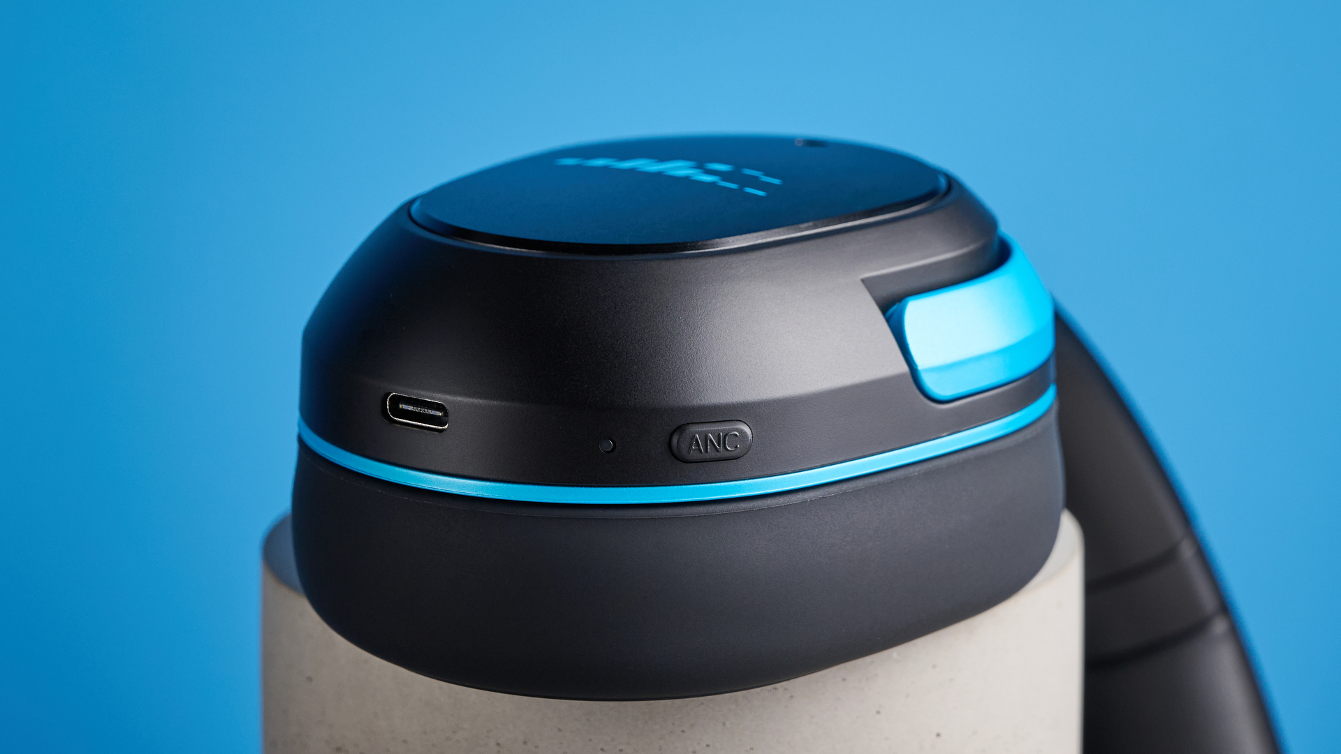 H2O RIPT Ultra headphones in black with blue accents photographed on a blue background