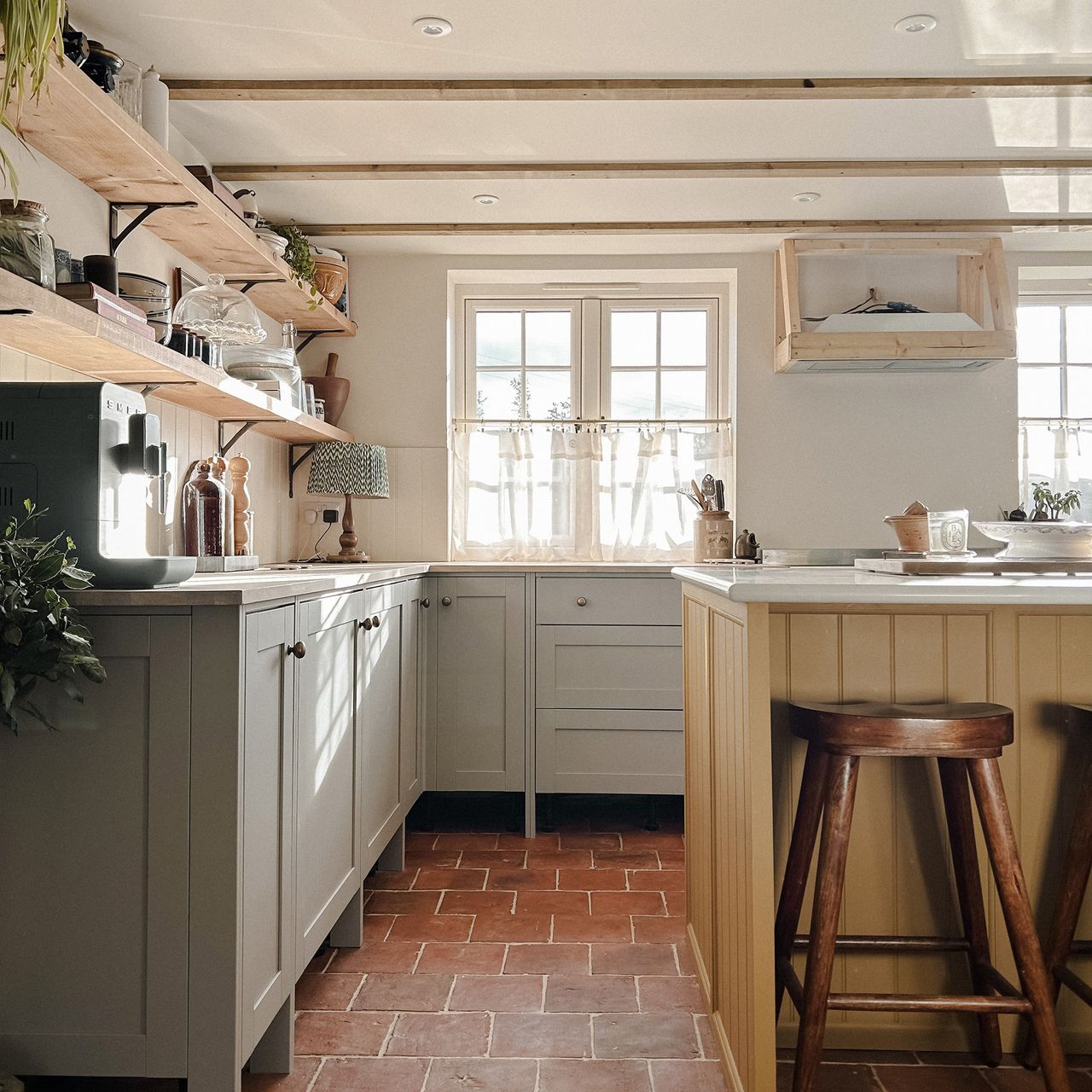 rustic kitchen with yellow island and grey cabinets