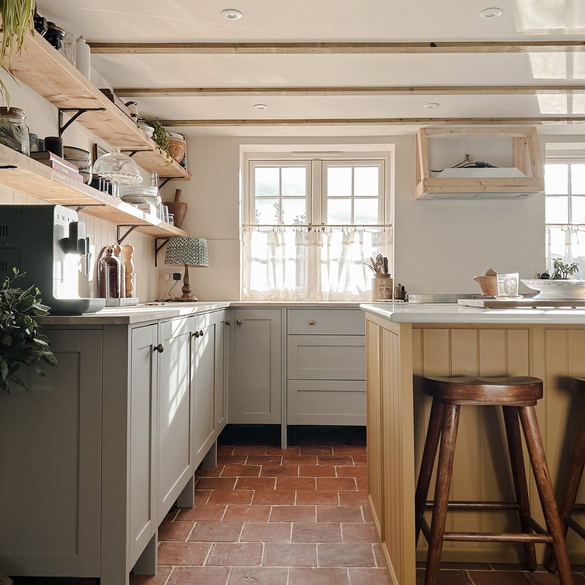 rustic kitchen with yellow island and grey cabinets