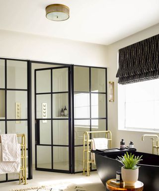 Modern bathroom with a black, gold, and white color scheme