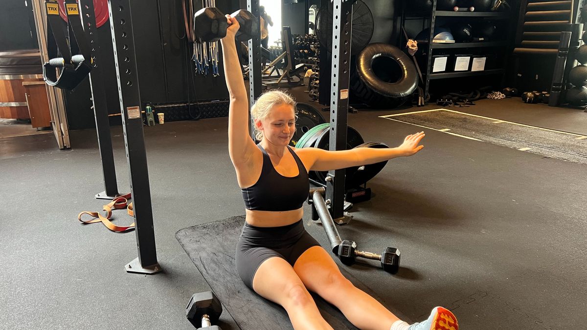 Woman performing Z press in gym