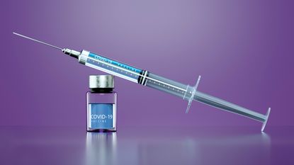 Image of a syringe and COVID-19 vaccine.