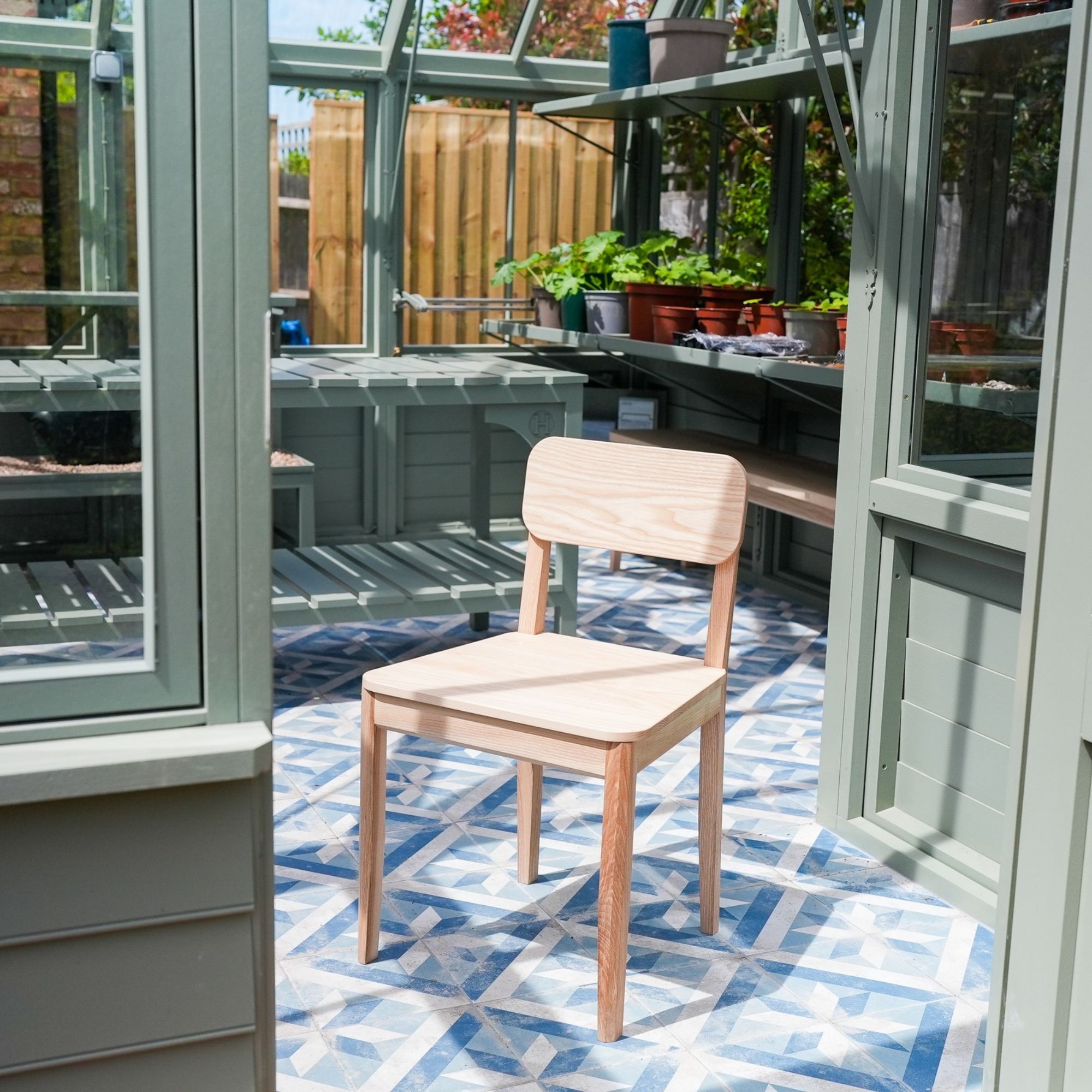 Wooden chair inside Hampton The Causeway greenhouse