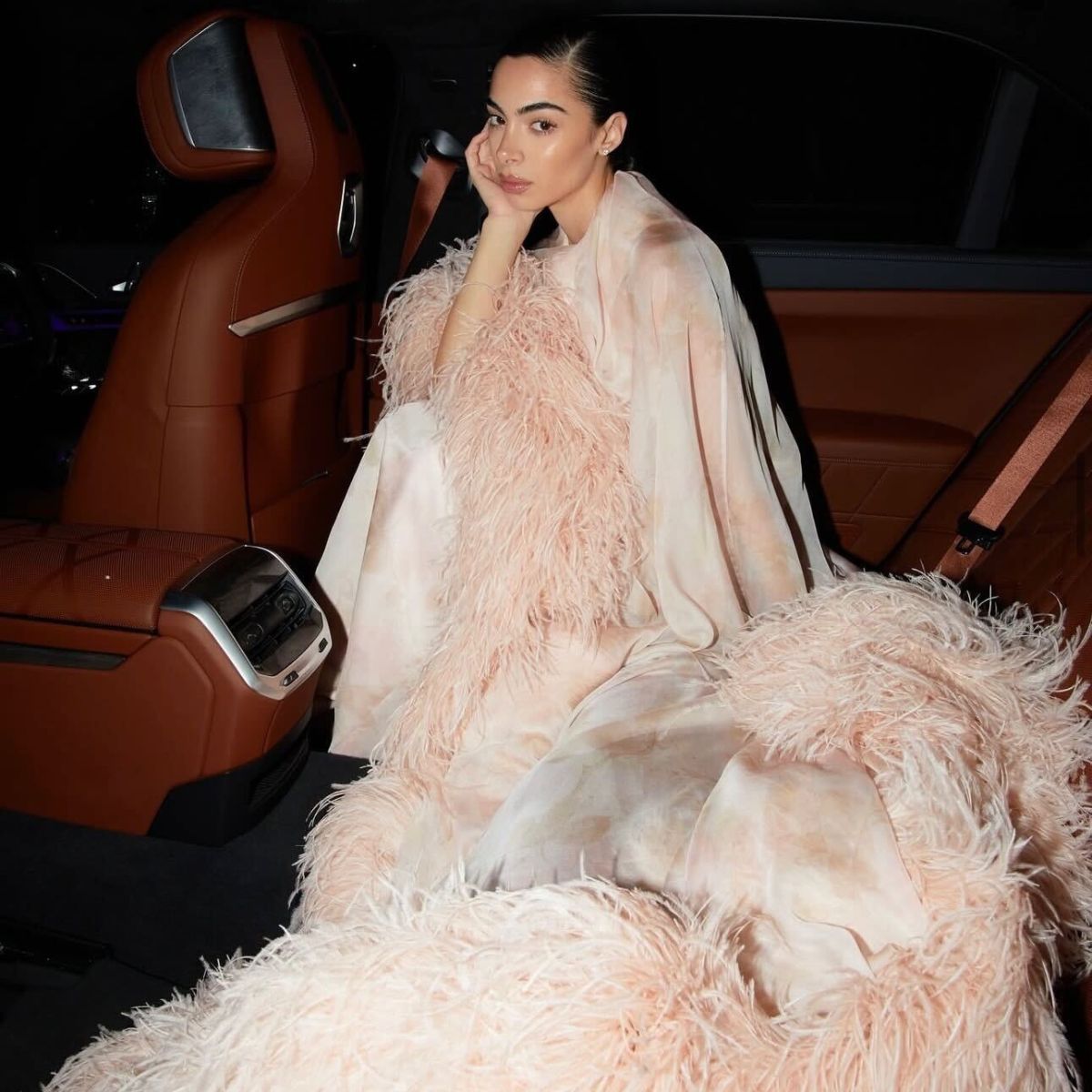 federica labanca in a car wearing a pink feathered dress