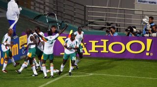 Senegal's players celebrate by the corner flag after Papa Bouba Diop's winning goal against France in the opening match of the 2002 FIFA World Cup on 31 May, 2002 in Seoul, Republic of Korea
