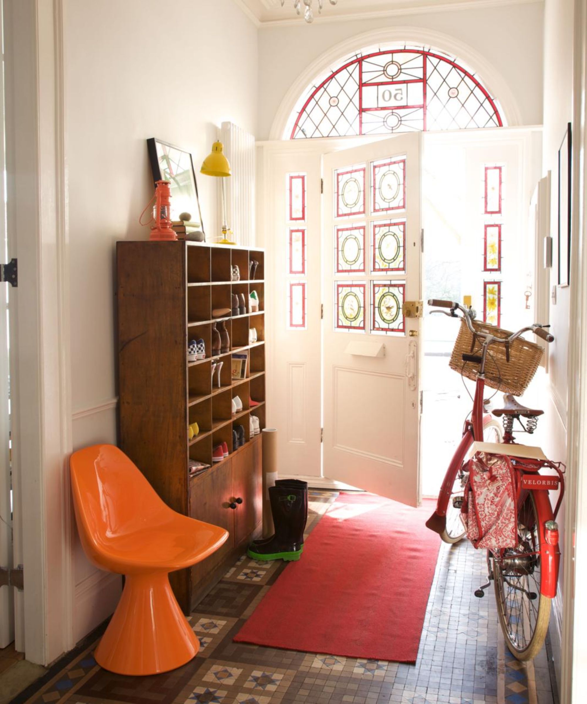an entryway with a red bike in it similar to the one in eva mendes and ryan gosling's home