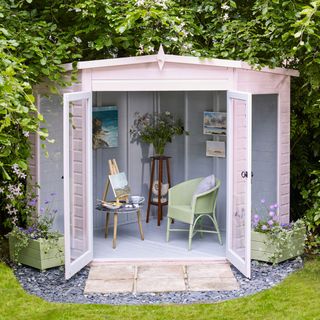 garden studio with wooden table and armchair