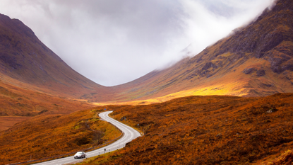 Car driving through Scottish mountains