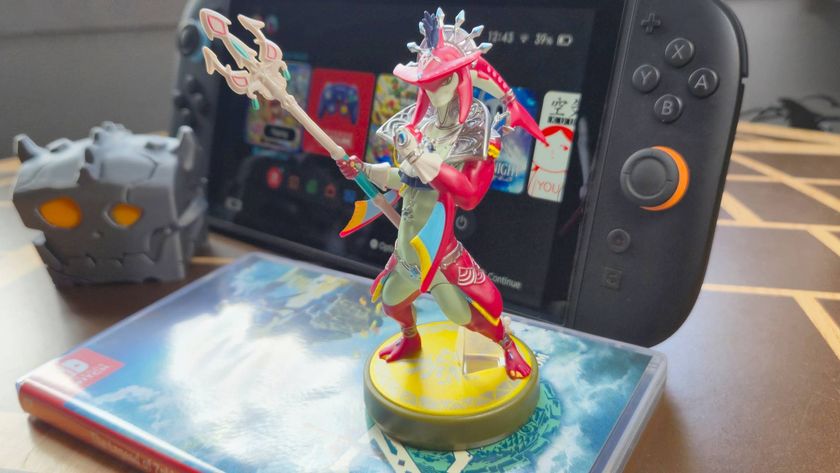 Photo by Rosalie Newcombe of the Sidon Tears of the Kingdom amiibo sitting in front of a Switch 2 on a wooden table.