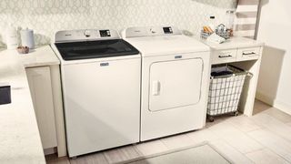 Maytag MVW6200KW top load washer in kitchen beside matching dryer