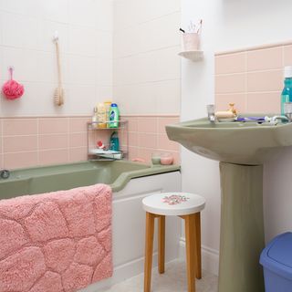 bathroom with tiled walls and bathtub