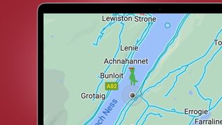 A laptop screen on a red background showing the Google Maps Easter egg for Loch Ness