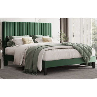 bed with large green headboard