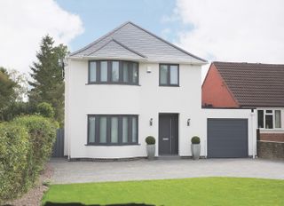 exterior to detached house with a grey and white design, that has been updated and modernised