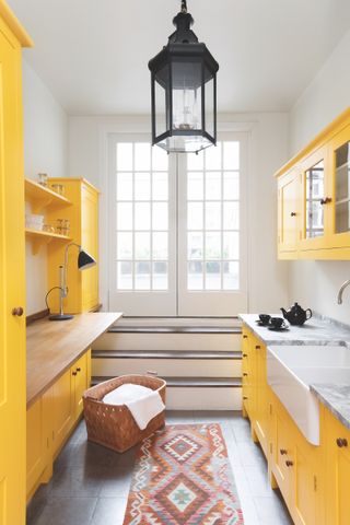 bright yellow galley kitchen