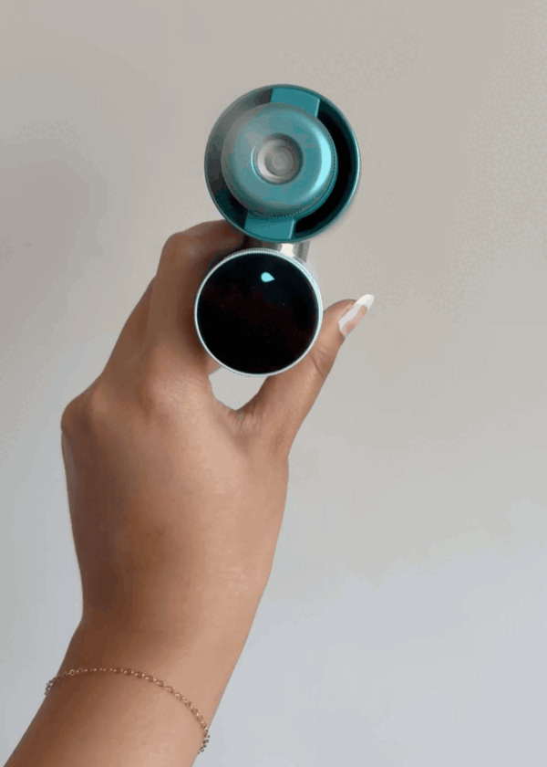 A video of the Shark handheld teal fan on misting mode