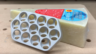 Apple Mac Pro replica next to a block of cheese
