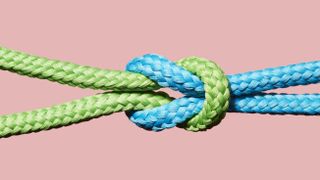 green and blue rope tangled on pink background