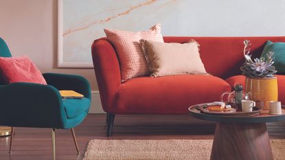 Living room with red sofa, coffee table and standing lamp.