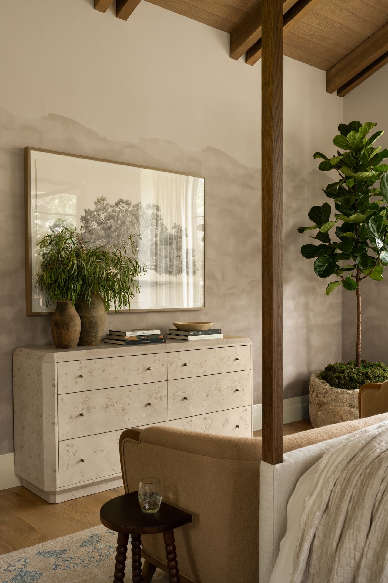 An angle of a dresser with a burl wood and a whitewash finish.