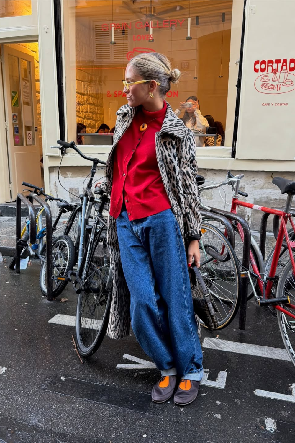 @caetanaba wears leopard coat, red cardigan and orange socks