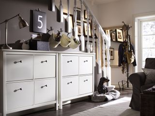 hallway with stair case and storage solutions