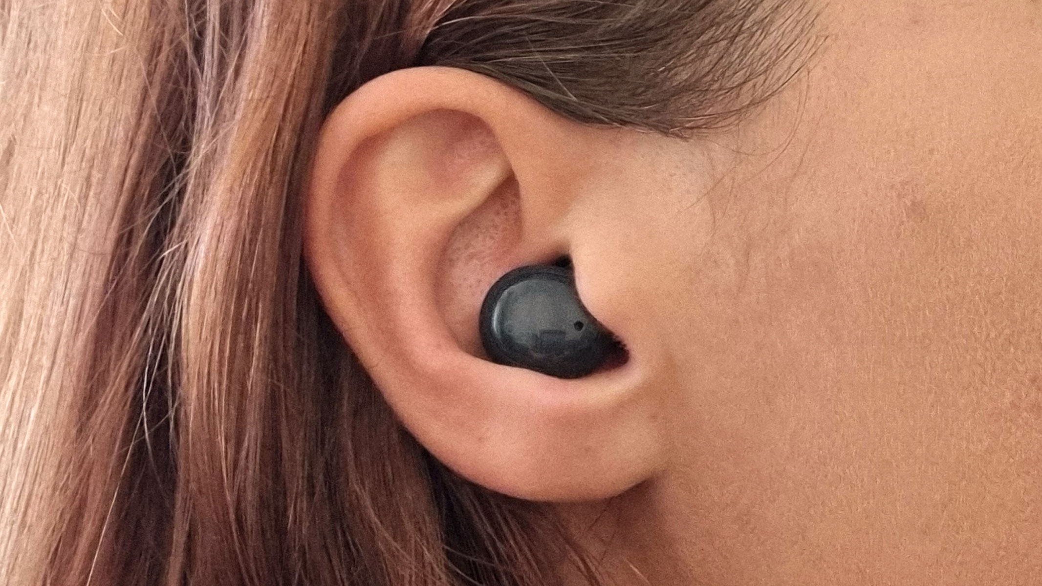 a close-up picture of our reviewer testing the Final ZE500 earbuds