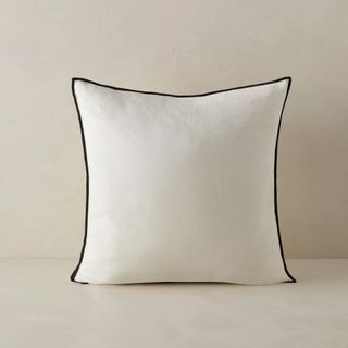 Carys Contrast Pillow against a beige background.