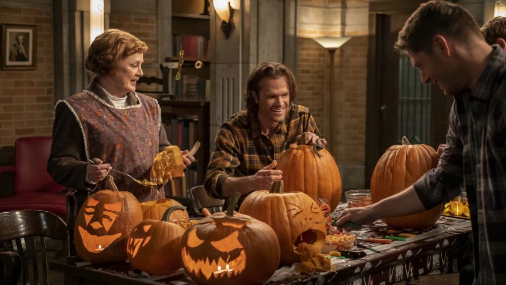 Sam, Dean and Mrs. Butters carve their pumpkins. 