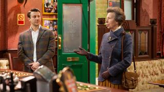 princess anne on the set of coronation street with suede bag