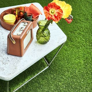 table with flower vase and radio