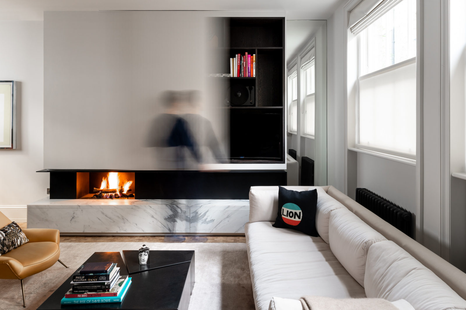 TV disguised behind a sliding door in a small white living room