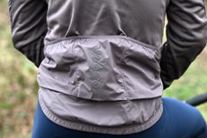 close up of 3 rear pockets on a purple cycling jacket.