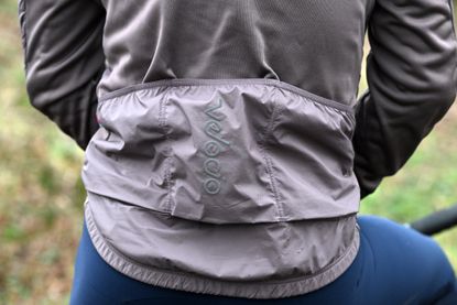 close up of 3 rear pockets on a purple cycling jacket.