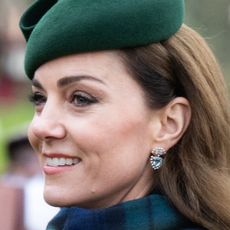 Kate Middleton wears a green hat and smiles while at Sandringham on Christmas Day