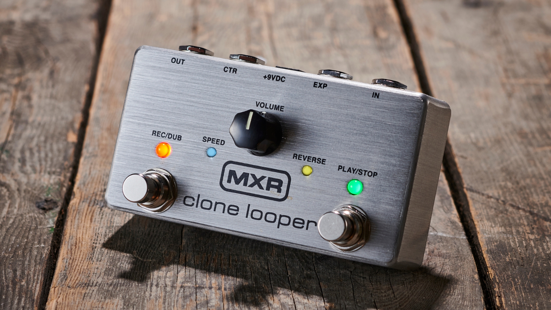 An MXR Clone Looper pedal on a wooden floor