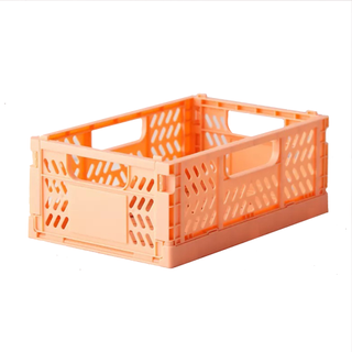 A pastel orange collapsible plastic storage crate