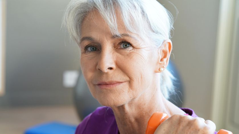 a senior woman holding a dumbbell