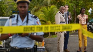 Death in Paradise season 11 - Marlon puts out police tape as the rest of the team look on