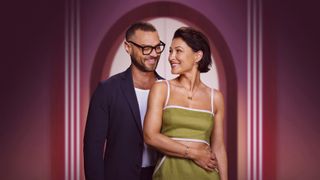 Love is Blind UK hosts, Emma Willis and Matt Willis, smile and stare at each other