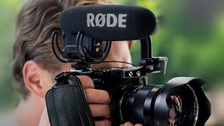 Man shooting with camera and the best microphone for vlogging and filmmaking