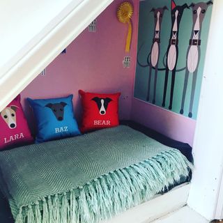 pink walled dogs room with bed and cushions