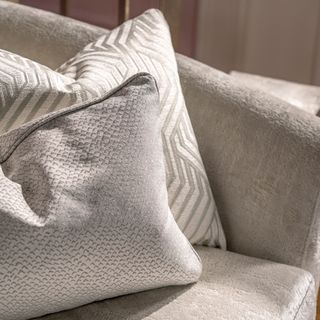 Tactile neutral cushions on a beige sofa
