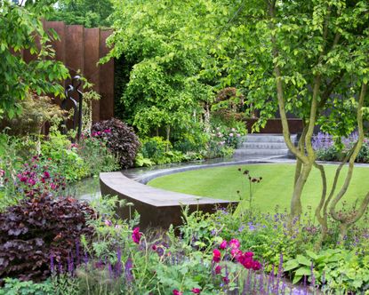 small garden design with circular lawn and curved bench