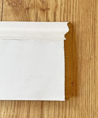 a piece of white skirting board cut at a 45 degree angle
