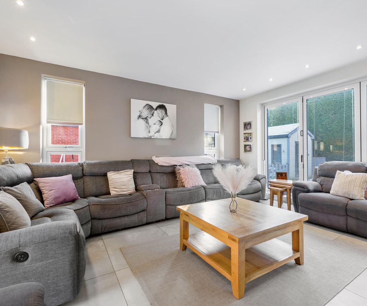 A living room with a grey corner sofa
