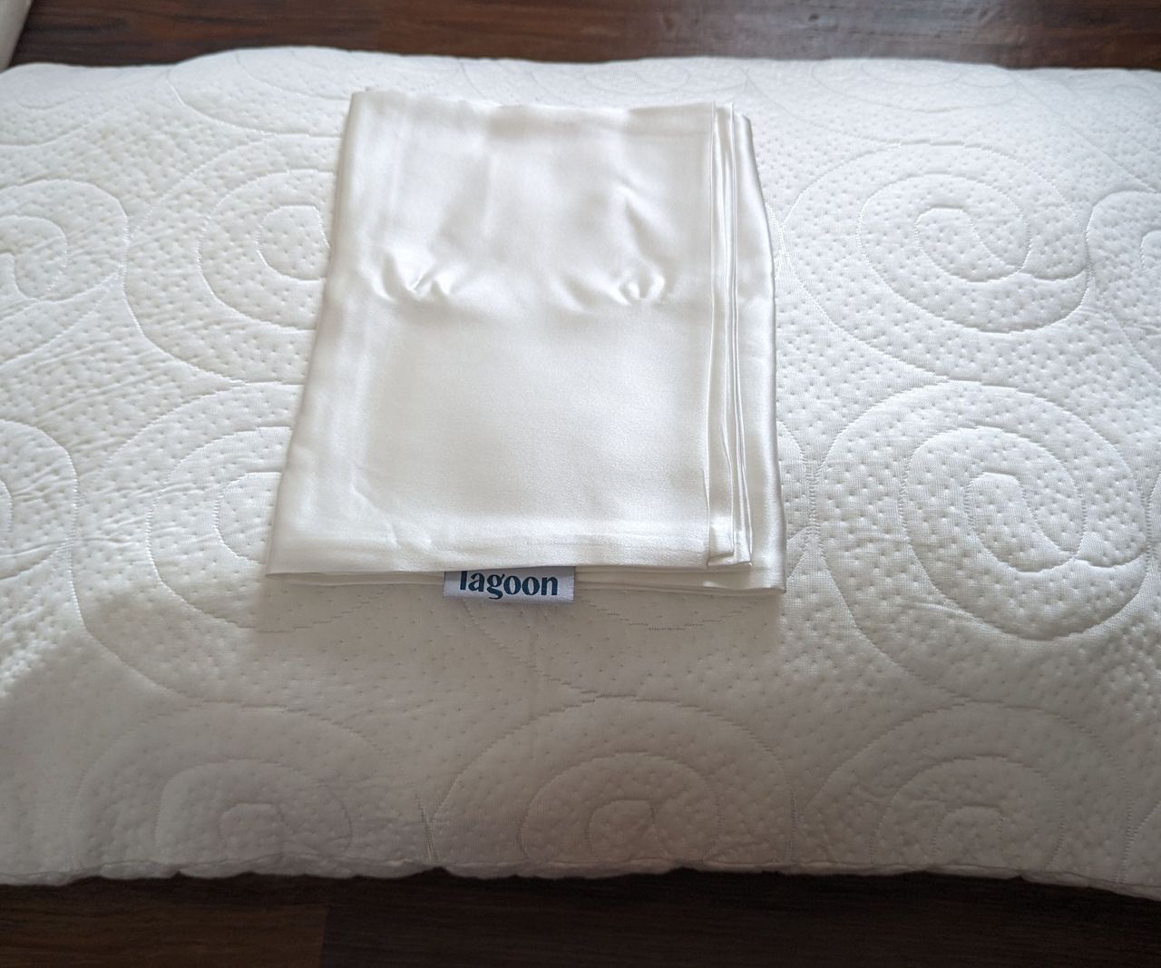 The Lagoon Silk Pillowcase on top the Lagoon Fox Pillow.