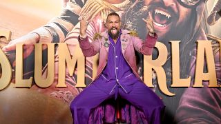 Jason Momoa posing with rocker hands and wearing PJs at the Slumberland premiere. 